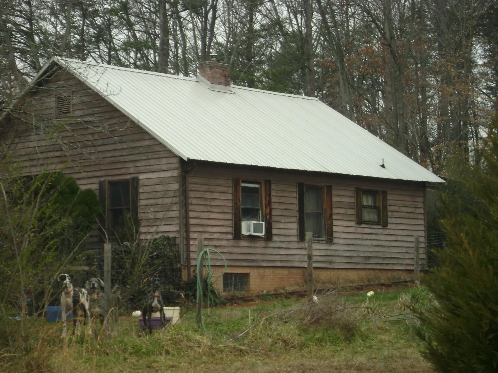 White metal roof on an old wood sided farmhouse, from a Metal Roof Installation job in Yorkville